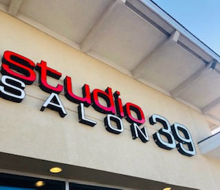 store front of Studio 39 Salon in red and gray letters